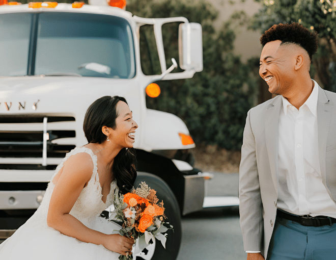 A couple exchanges loving smiles beside a parked tow truck, highlighting the harmony between their marriage and their towing service in San Jose.